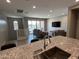 Modern kitchen featuring granite countertops and an open-concept design overlooking the living area at 4073 E Amoroso Dr, Gilbert, AZ 85296
