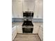 Close-up of modern stainless steel range and microwave with granite countertops and white cabinets at 4073 E Amoroso Dr, Gilbert, AZ 85296