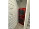 Stacked red washer and dryer in laundry closet with tiled floors at 4073 E Amoroso Dr, Gilbert, AZ 85296
