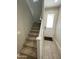 Carpeted staircase with white railing leads to the upper level of the home, door nearby at 4073 E Amoroso Dr, Gilbert, AZ 85296