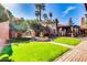 Landscaped courtyard with manicured lawn, decorative fountain, and picturesque pergola at 4203 E Hazelwood St, Phoenix, AZ 85018