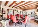 Elegant dining room featuring exposed beams, chandelier, and seating for eight guests at 4203 E Hazelwood St, Phoenix, AZ 85018