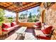 Inviting outdoor patio with comfortable seating, brick flooring, and beautiful views of the surrounding landscape at 4203 E Hazelwood St, Phoenix, AZ 85018