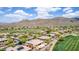 A high angle showcases community homes adjacent to the golf course, framed by the majestic mountains at 42109 N Astoria Way, Anthem, AZ 85086
