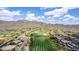 Expansive aerial view showcasing the community, golf course, and stunning mountain backdrop at 42109 N Astoria Way, Anthem, AZ 85086