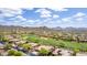 A high angle shows residences nestled among the golf course, complemented by a captivating mountain range at 42109 N Astoria Way, Anthem, AZ 85086