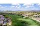 A wide angle aerial captures community homes along the golf course with mountains as the backdrop at 42109 N Astoria Way, Anthem, AZ 85086