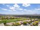 A picturesque community panorama with meticulously landscaped homes, a lush green golf course, and distant mountain views at 42109 N Astoria Way, Anthem, AZ 85086