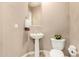 Powder room featuring a pedestal sink, toilet, decorative flower arrangement, and tile flooring at 42109 N Astoria Way, Anthem, AZ 85086