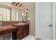 Stylish bathroom featuring a custom vanity with marble countertop, decorative mirror, and ample cabinet space at 42109 N Astoria Way, Anthem, AZ 85086