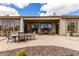 Expansive covered patio with multiple seating areas and lush desert landscaping at 42109 N Astoria Way, Anthem, AZ 85086