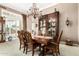 Dining room with a decorative cabinet, dining table and chandelier at 42109 N Astoria Way, Anthem, AZ 85086