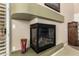 Close-up of a modern fireplace with sleek design and a glass block accent wall in the background at 42109 N Astoria Way, Anthem, AZ 85086