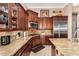Gourmet kitchen featuring granite countertops, stainless steel appliances, and dark wood cabinetry at 42109 N Astoria Way, Anthem, AZ 85086
