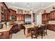 Gourmet kitchen featuring granite countertops, stainless steel appliances, and dark wood cabinetry is an entertainer's delight at 42109 N Astoria Way, Anthem, AZ 85086