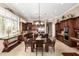 Open-concept kitchen and dining area with granite countertops, stainless steel appliances, and dark wood cabinetry at 42109 N Astoria Way, Anthem, AZ 85086