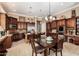 Open-concept kitchen with granite countertops, stainless steel appliances, and a seamless flow to the dining area at 42109 N Astoria Way, Anthem, AZ 85086