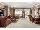An open living and dining area features a decorative cabinet and comfortable seating at 42109 N Astoria Way, Anthem, AZ 85086