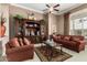 Comfortable living room has a decorative cabinet and plush seating at 42109 N Astoria Way, Anthem, AZ 85086