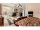 Open main bedroom featuring a fireplace, seating area, and view into the sleeping area with a large bed at 42109 N Astoria Way, Anthem, AZ 85086