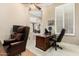 Home office featuring a dark wood desk, leather chairs, and a comfortable workspace at 42109 N Astoria Way, Anthem, AZ 85086