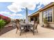 Outdoor dining area on the back patio with comfortable seating and lush landscaping at 42109 N Astoria Way, Anthem, AZ 85086