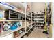 Walk-in pantry features ample shelving stocked with food items, kitchen supplies, and cleaning tools at 42109 N Astoria Way, Anthem, AZ 85086