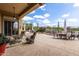 Comfortable covered patio includes plush seating with a ceiling fan and views of the landscaped yard at 42109 N Astoria Way, Anthem, AZ 85086