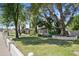Large backyard with lush green lawn, mature trees and patio feature at 430 N Vineyard --, Mesa, AZ 85201