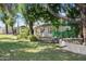Lush backyard with a tree swing, green patio, and mature foliage at 430 N Vineyard --, Mesa, AZ 85201