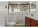 Stylish bathroom featuring a glass shower, wood vanity, and tropical wallpaper at 430 N Vineyard --, Mesa, AZ 85201