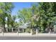 Traditional home with a well-manicured lawn, mature trees, and a decorative white brick fence at 430 N Vineyard --, Mesa, AZ 85201