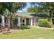 Charming single story home with a green door, flag, and mature landscaping at 430 N Vineyard --, Mesa, AZ 85201