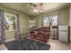 Cozy living room with a ceiling fan, comfortable seating, and natural light from surrounding windows at 430 N Vineyard --, Mesa, AZ 85201