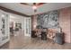 Large home office featuring a brick accent wall, tiled floors, and a ceiling fan at 430 N Vineyard --, Mesa, AZ 85201