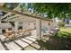 Inviting backyard patio area with a pergola, picnic tables, and an outdoor grilling station at 430 N Vineyard --, Mesa, AZ 85201