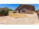 A well-maintained backyard featuring a lawn, desert landscaping, and gravel at 44899 W Portabello Rd, Maricopa, AZ 85139