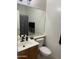 Bathroom featuring a modern sink, stylish vanity, and a toilet with a matching black accent shelf at 44899 W Portabello Rd, Maricopa, AZ 85139