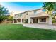 Expansive backyard featuring lush green grass, a covered patio, and well-maintained landscaping at 4494 E Reins Rd, Gilbert, AZ 85297