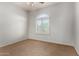 Bright and airy bedroom with neutral carpet, window, and a ceiling fan at 4494 E Reins Rd, Gilbert, AZ 85297