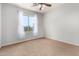 Bedroom with window, white sheer curtains, neutral paint, and carpet at 4494 E Reins Rd, Gilbert, AZ 85297