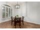 Cozy dining area with a round wooden table, seating for four, and a window with natural light at 4494 E Reins Rd, Gilbert, AZ 85297