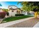 Well-maintained home featuring a lush lawn, attractive landscaping, and unique architectural detailing at 4494 E Reins Rd, Gilbert, AZ 85297