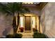 Inviting front entrance featuring a wood door, sidelight windows, and decorative plants at 4494 E Reins Rd, Gilbert, AZ 85297