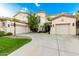 Elegant home showcasing a three-car garage, palm trees, and a well-manicured lawn for curb appeal at 4494 E Reins Rd, Gilbert, AZ 85297