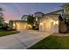Home features a lush lawn, mature trees, and a three car garage at 4494 E Reins Rd, Gilbert, AZ 85297