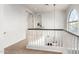 Hallway with elegant railing, an arched window and a decorative niche for plants and decor at 4494 E Reins Rd, Gilbert, AZ 85297