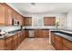 Spacious kitchen with stainless steel appliances, dark countertops, and wood cabinetry at 4494 E Reins Rd, Gilbert, AZ 85297