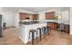 Kitchen boasting dark wood cabinets, black countertops, seating bar, and tile flooring at 4494 E Reins Rd, Gilbert, AZ 85297