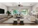 Bright living room featuring neutral colors, large windows, modern furniture, and inviting seating areas at 4494 E Reins Rd, Gilbert, AZ 85297